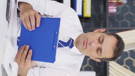 Vertical-video-of-Businessman-thinks-looking-at-documents.